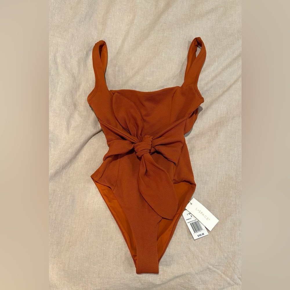 L Space rust one piece swim suit.  New with tags and protective liner